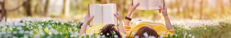 mom and son reading in a field