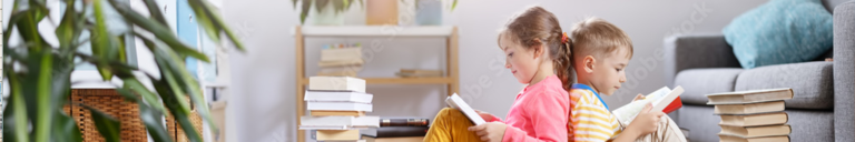 Two children sitting on the floor in the room and reading books