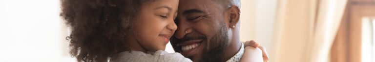 little girl hugging father